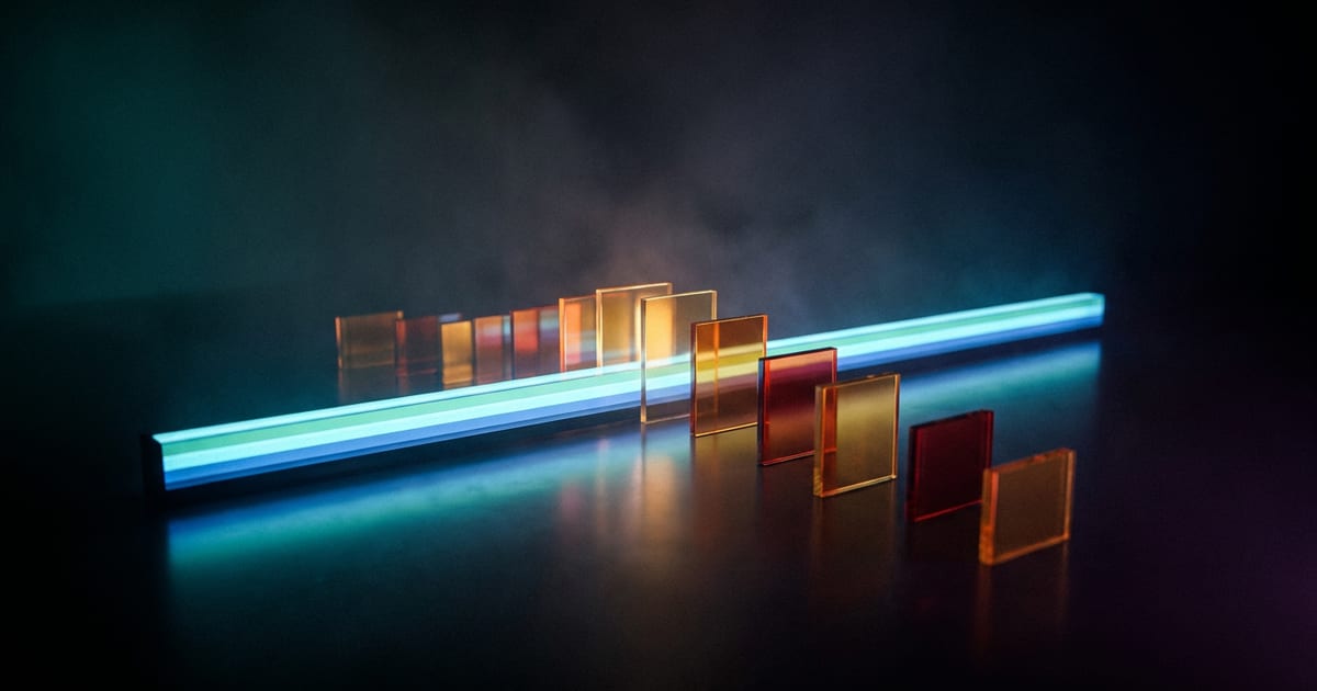 A long bar of light with many small upright glowing panels rising out of it